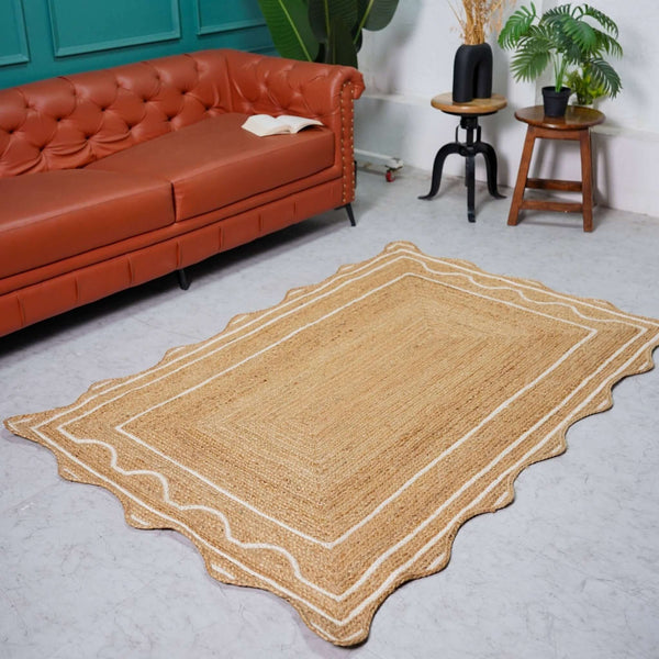 Handwoven natural hemp rug with scalloped white wavy border in beige